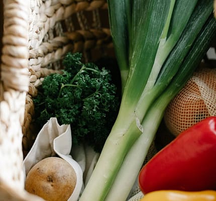 pexels-photo-7262909 A collection of fresh organic vegetables like leek, pepper, and potato in a wicker basket, perfect for cooking inspiration.